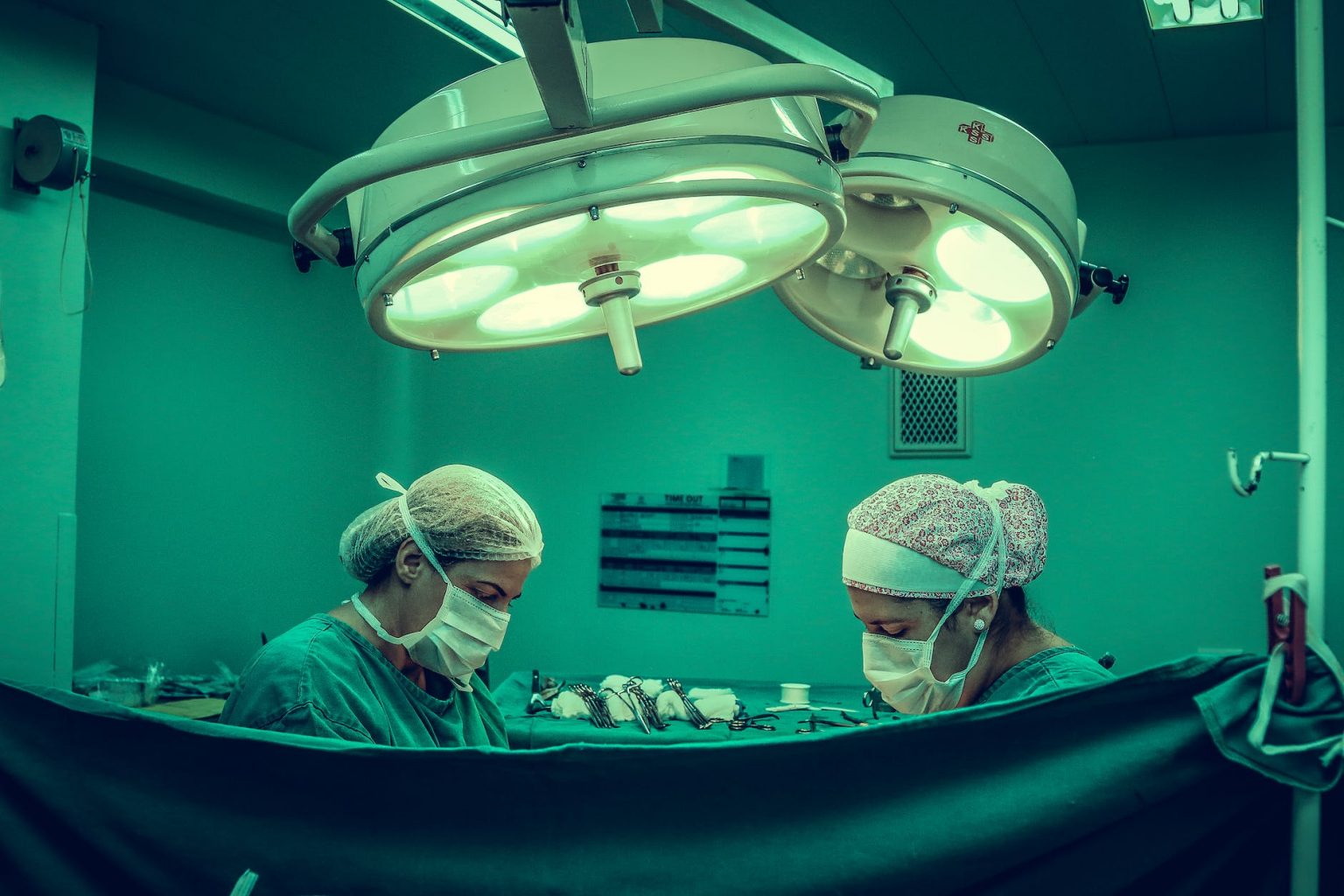 two person doing surgery inside room