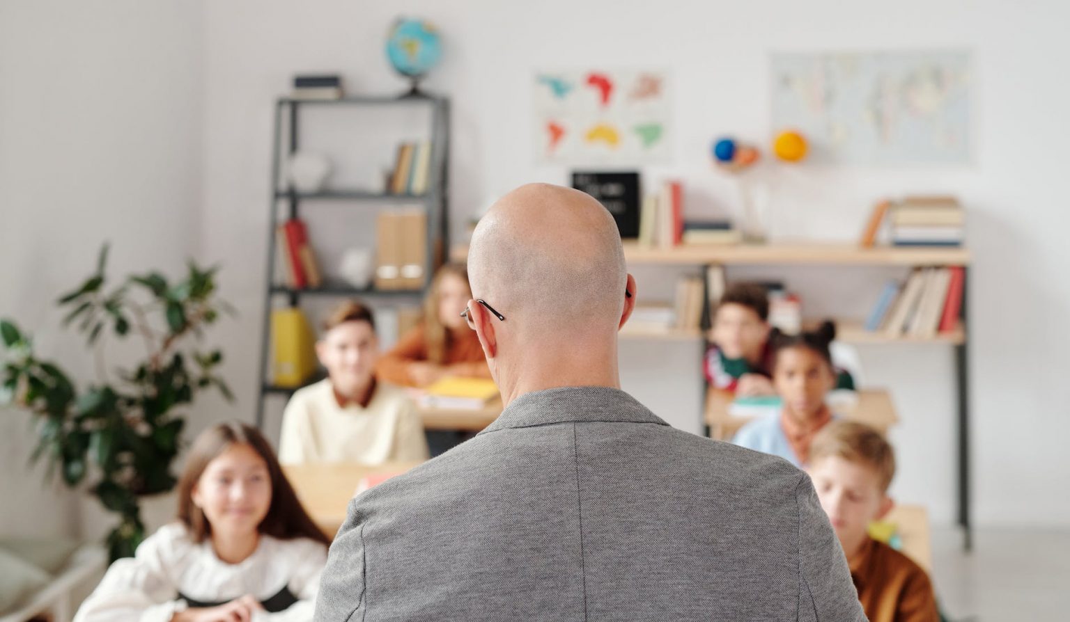 man in a gray shirt in front of the students