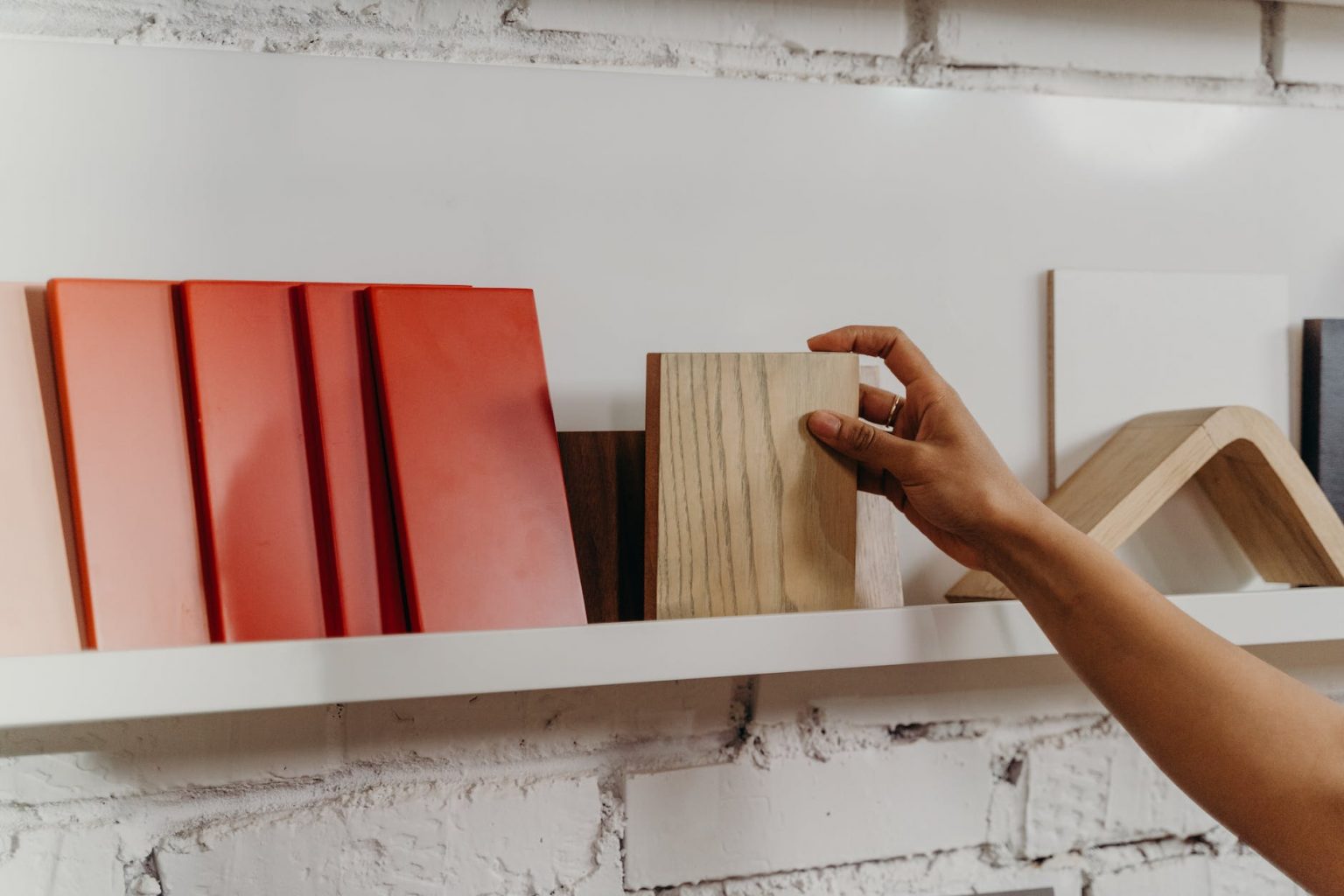 person holding wooden tiles