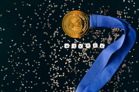 close up shot of a gold medal on a black surface